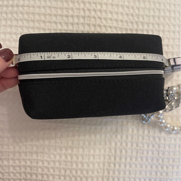 Dior black “CD” raised emblem silver & pearl wristlet & carriage keychain
